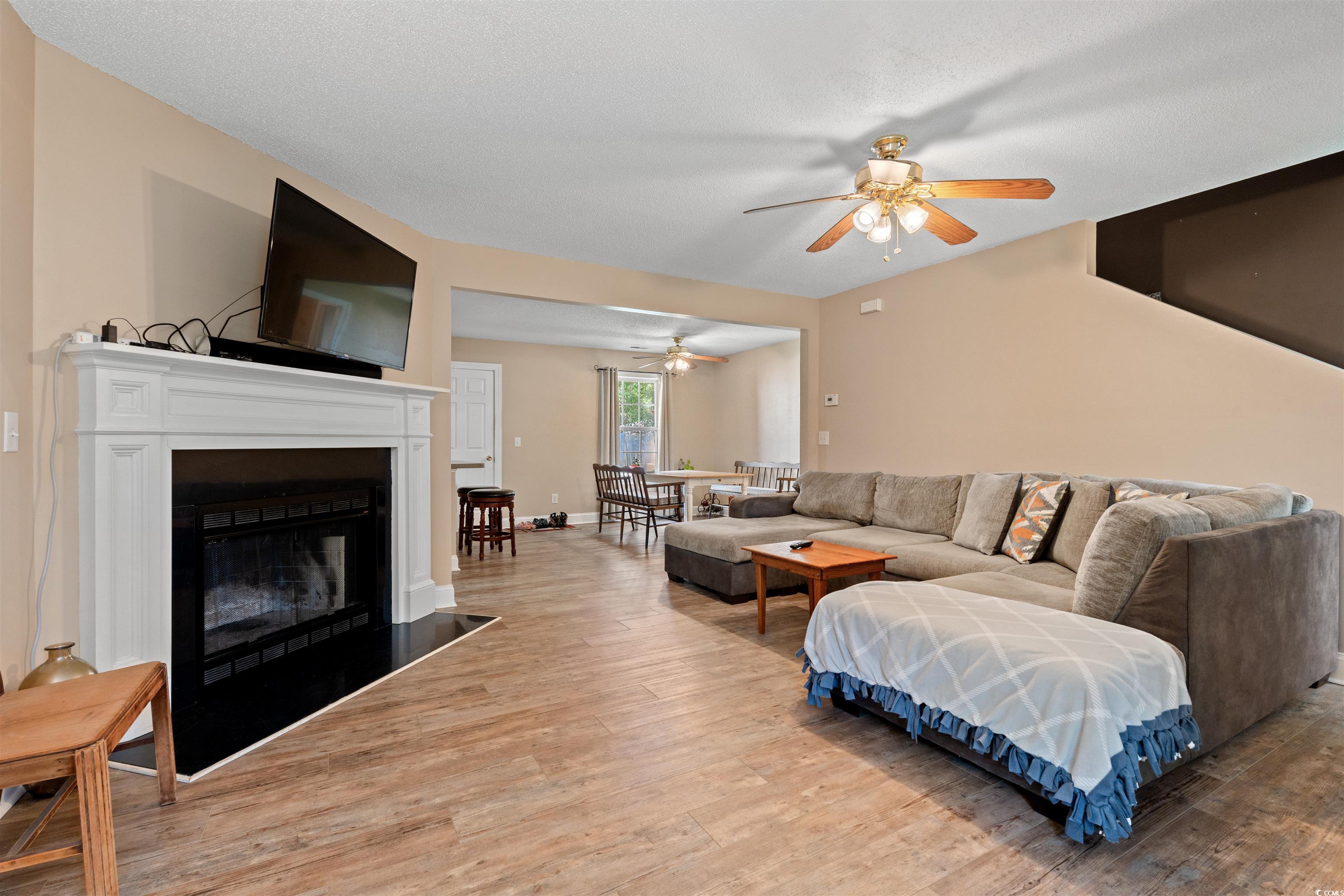 938 Fox Hollow Road Conway, SC 29526 - Photo 2 of 39 Living room with ceiling fan, light wood-type flooring, and a fireplace