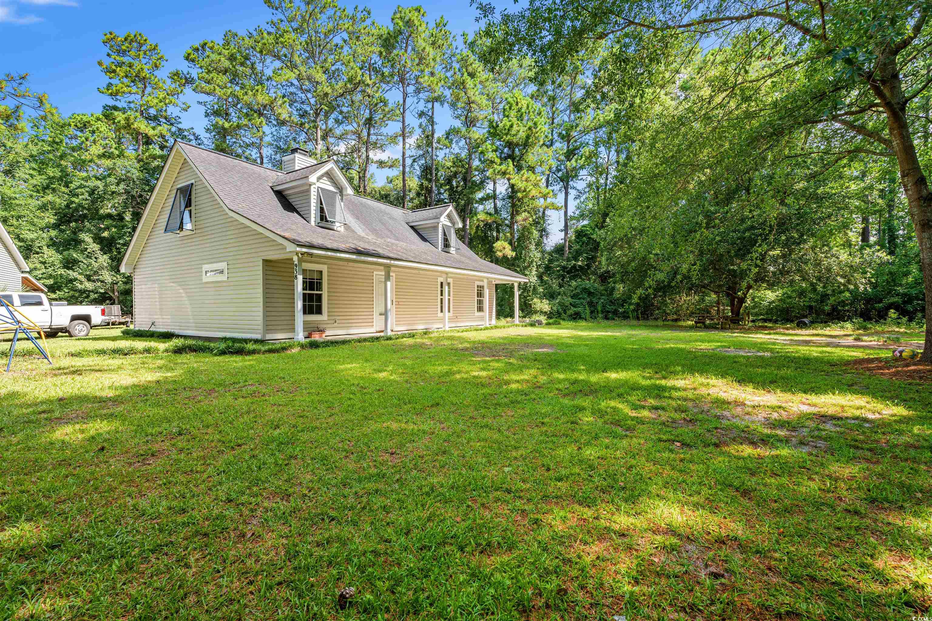 938 Fox Hollow Road Conway, SC 29526 - Photo 23 of 39 View of property exterior with a lawn and a chimney