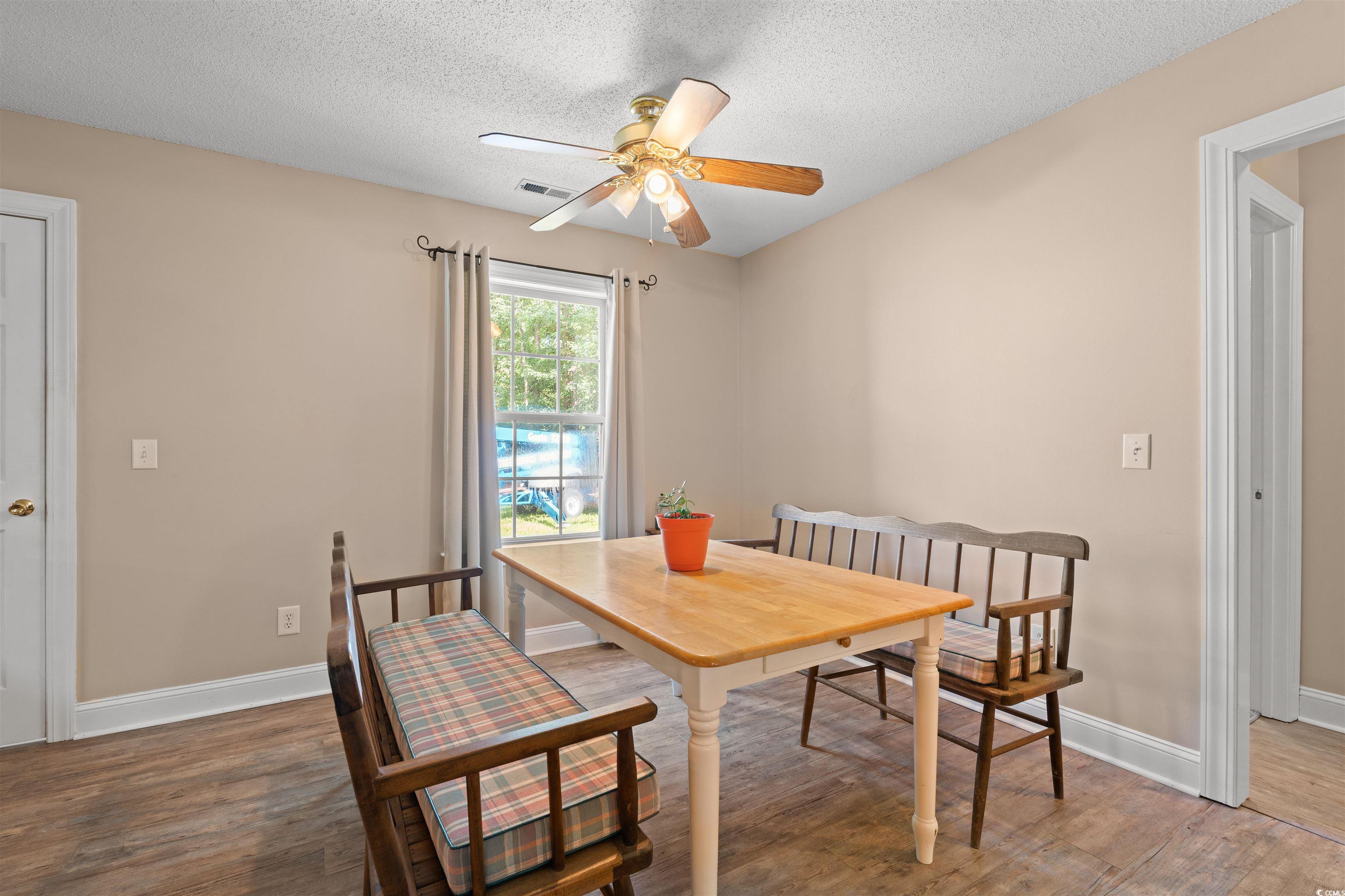 938 Fox Hollow Road Conway, SC 29526 - Photo 6 of 39 Dining space featuring wood finished floors, ceiling fan, and a textured ceiling