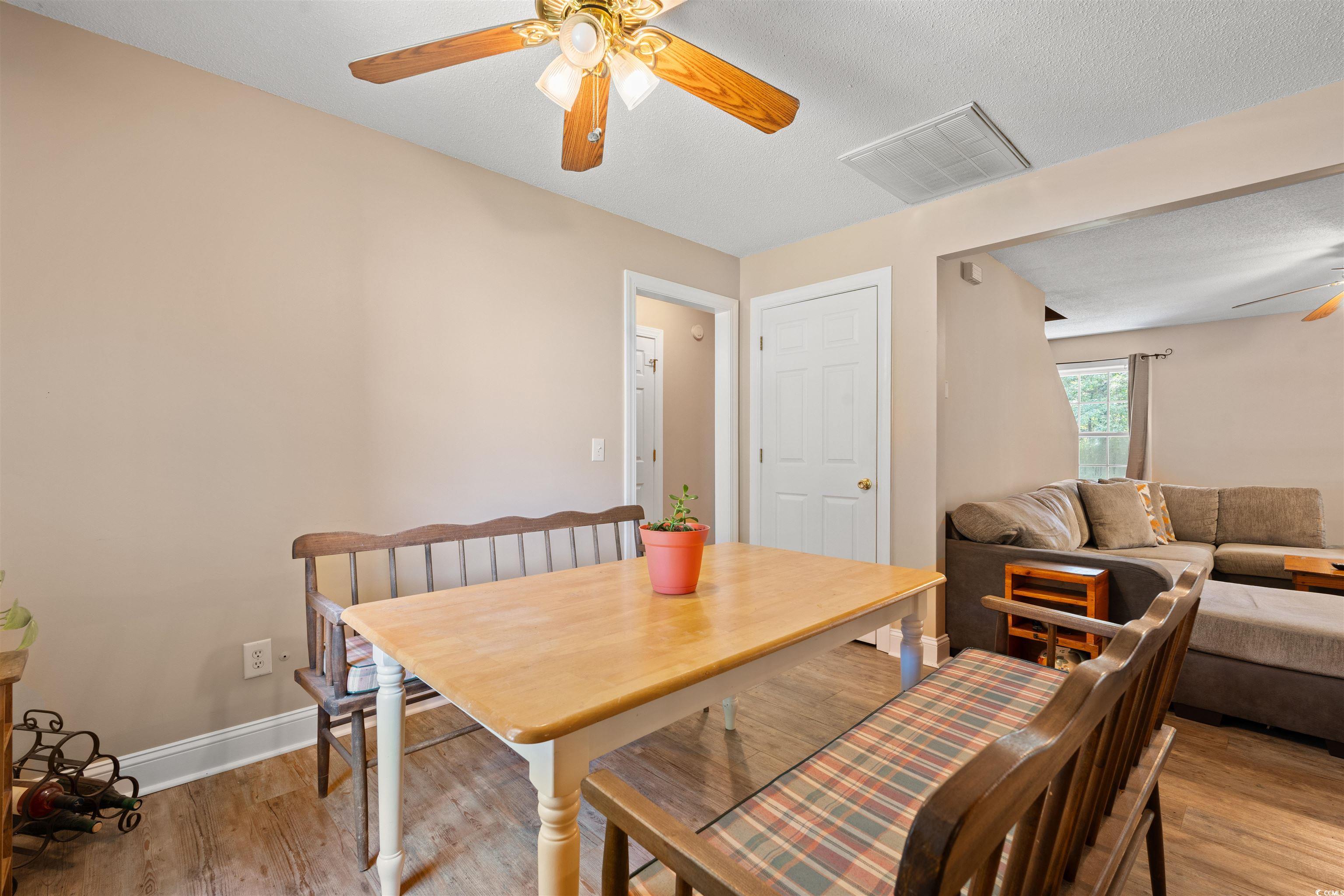 938 Fox Hollow Road Conway, SC 29526 - Photo 7 of 39 Dining room with ceiling fan, light wood-style flooring, and a textured ceiling