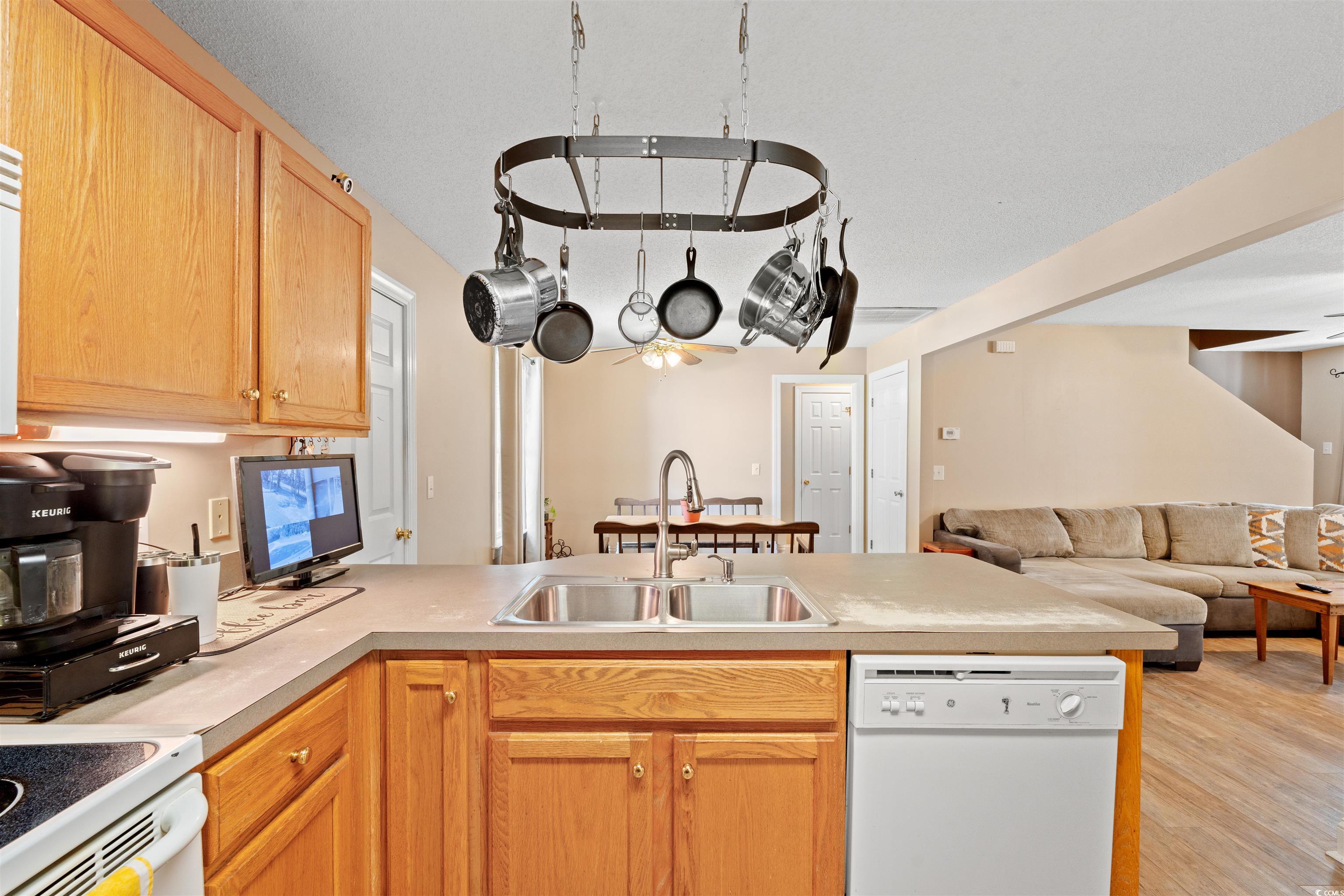 938 Fox Hollow Road Conway, SC 29526 - Photo 39 of 39 Kitchen with white appliances, a peninsula, open floor plan, light countertops, and light wood finished floors