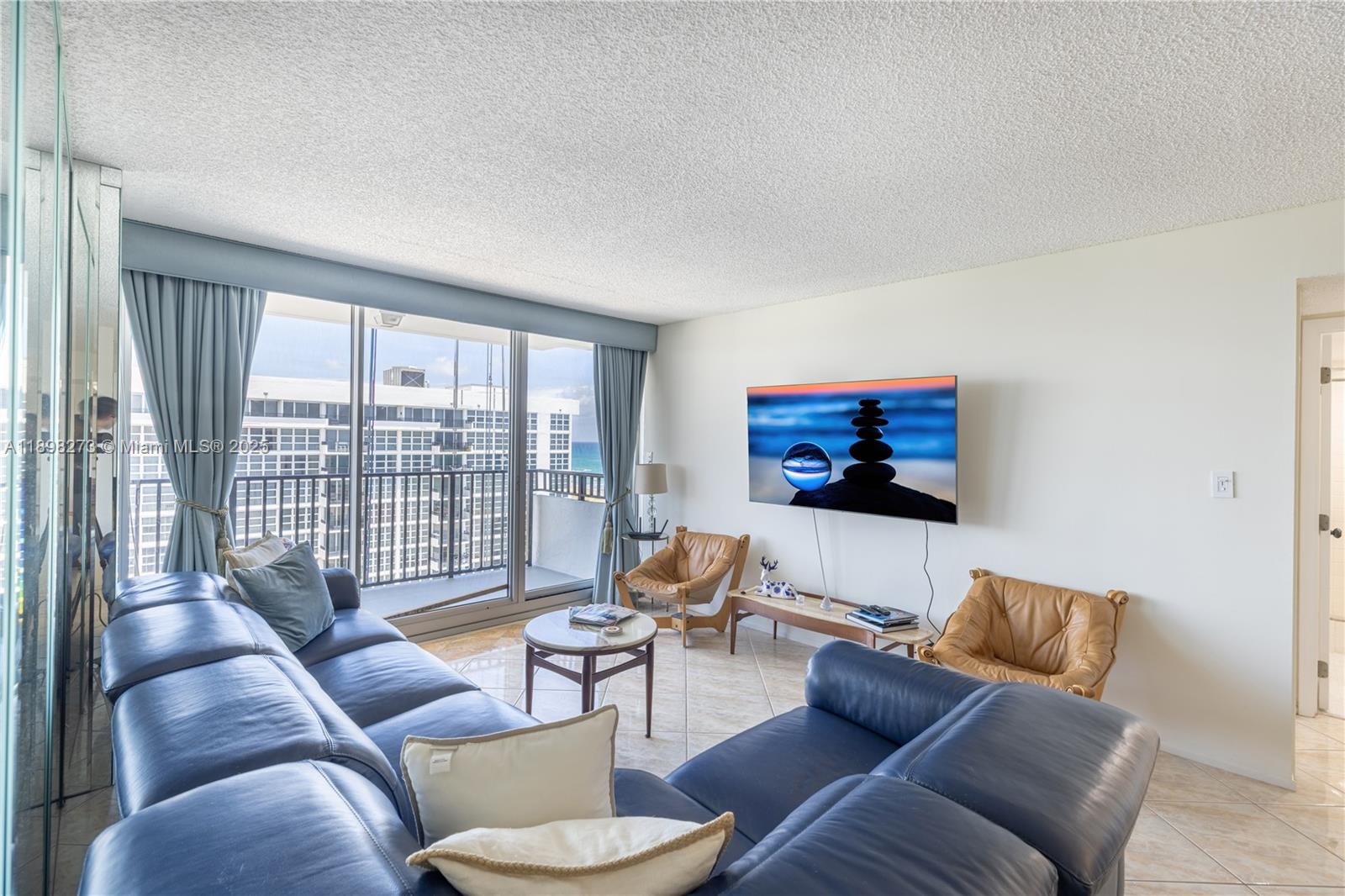 525 North Ocean Boulevard, Unit 1820 Pompano Beach, FL 33062 - Photo 1 of 18 a living room with furniture and a flat screen tv