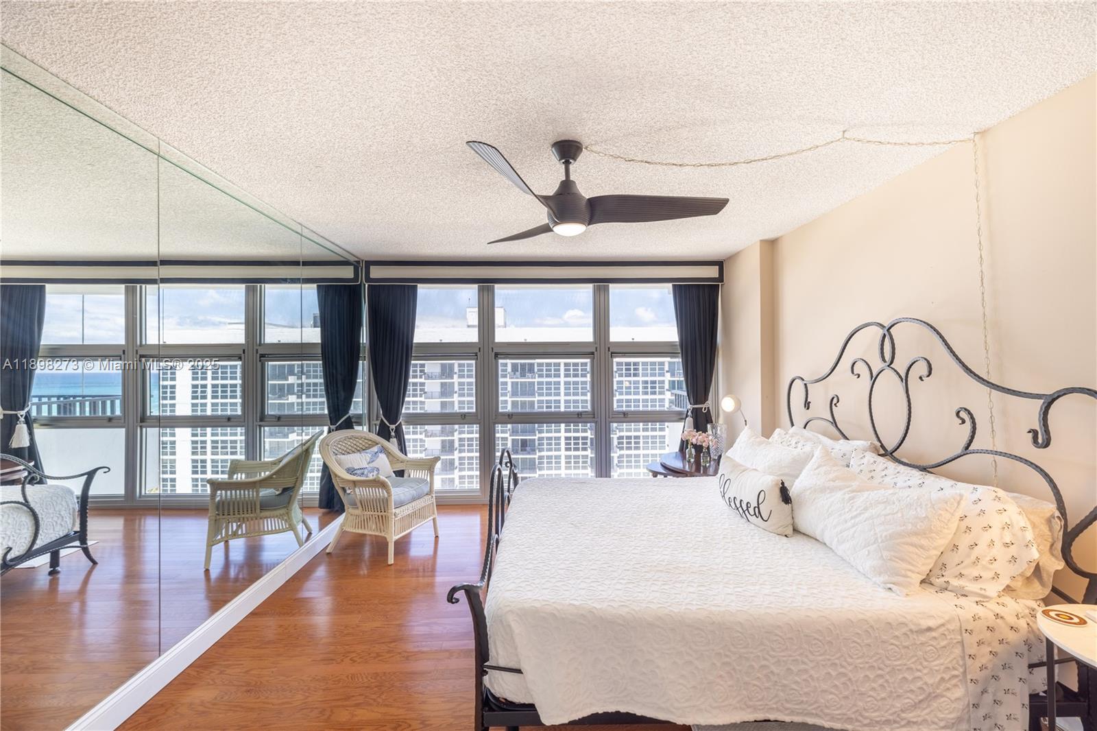 525 North Ocean Boulevard, Unit 1820 Pompano Beach, FL 33062 - Photo 11 of 18 a bedroom with furniture and a large window