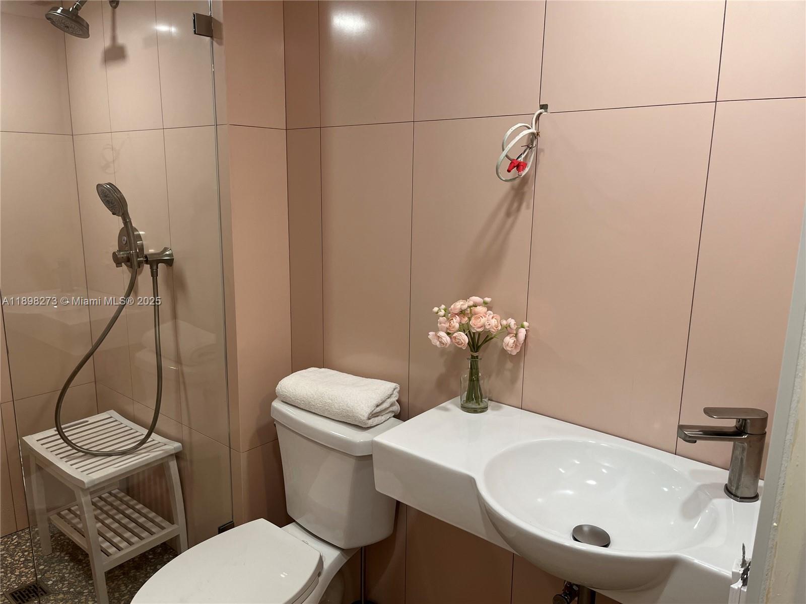 525 North Ocean Boulevard, Unit 1820 Pompano Beach, FL 33062 - Photo 13 of 18 a bathroom with a sink a toilet and a mirror