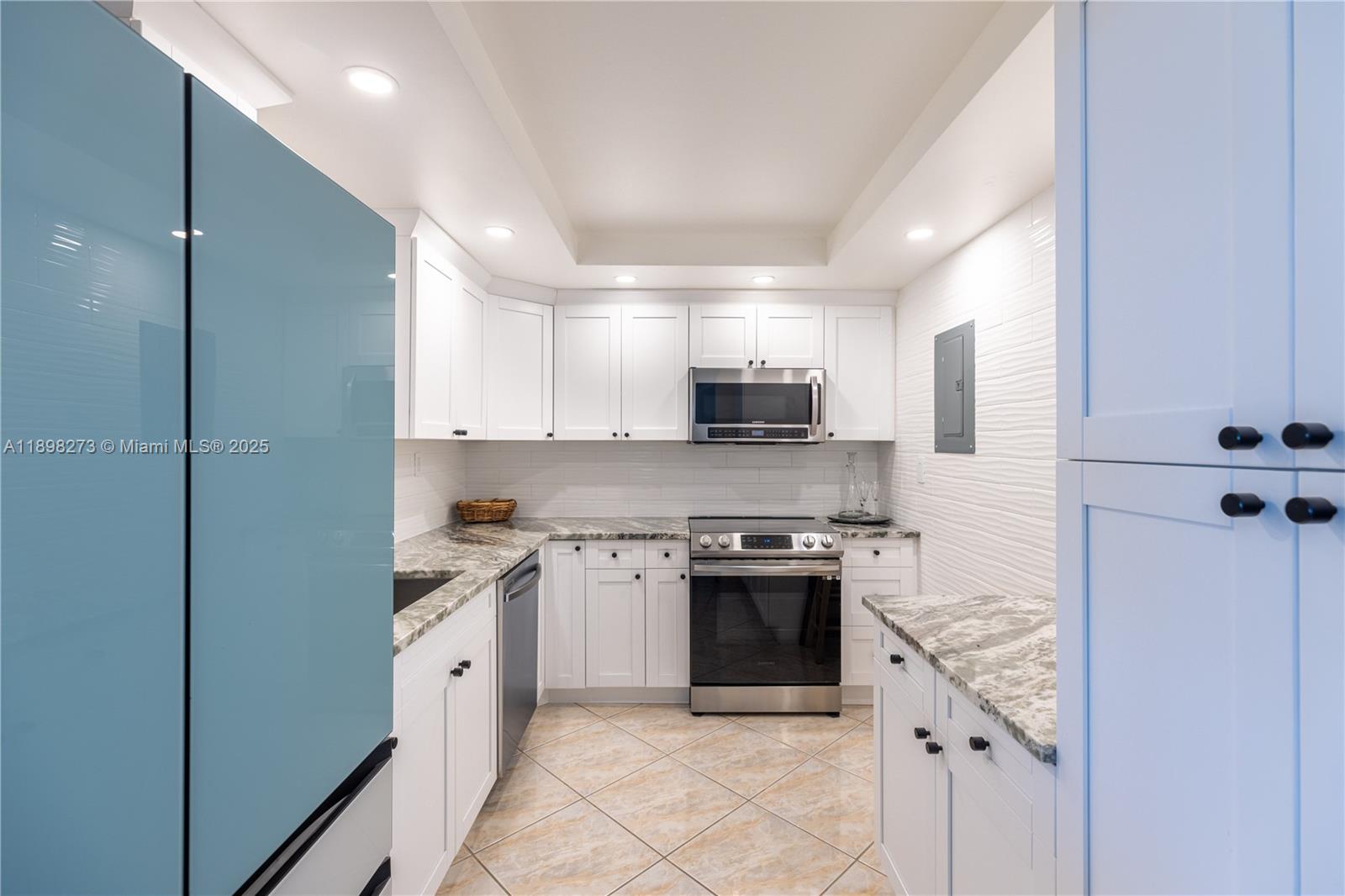 525 North Ocean Boulevard, Unit 1820 Pompano Beach, FL 33062 - Photo 3 of 18 a kitchen with stainless steel appliances granite countertop a stove a sink and a refrigerator