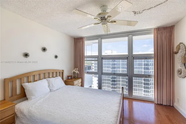 a bedroom with furniture and wooden floor