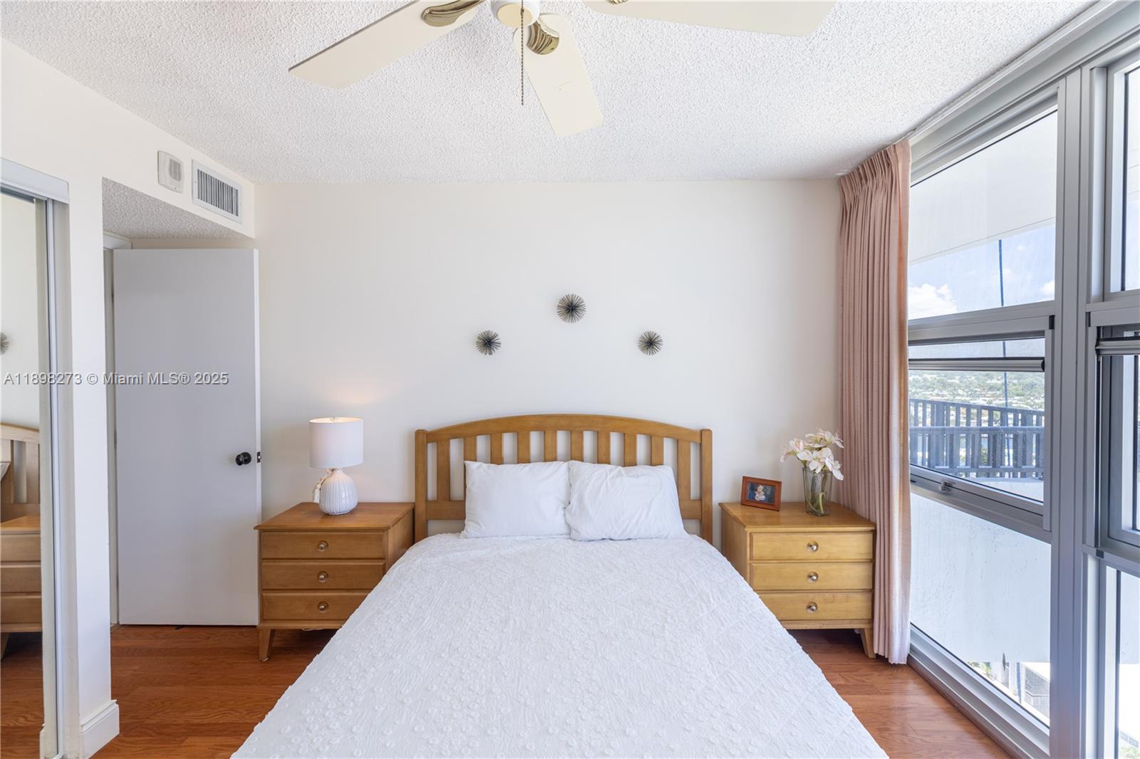 525 North Ocean Boulevard, Unit 1820 Pompano Beach, FL 33062 - Photo 8 of 18 a bedroom with a bed and wooden floor