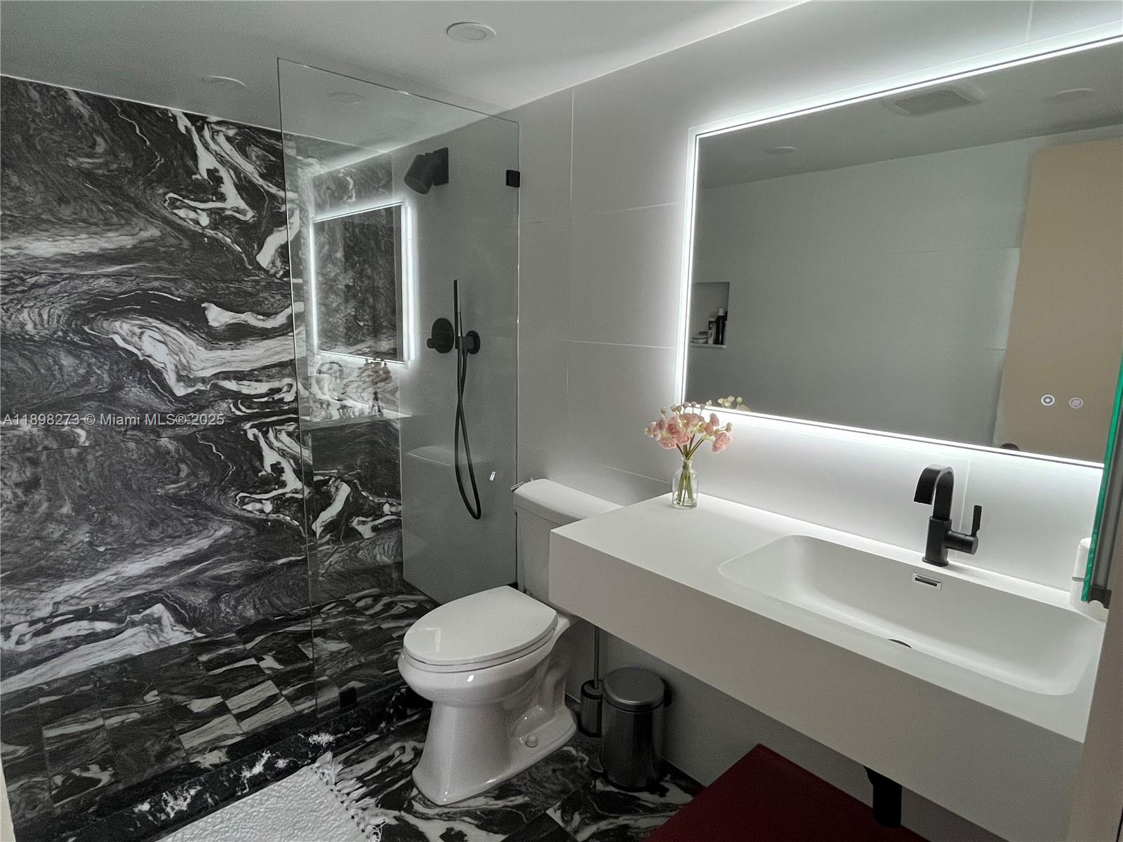 525 North Ocean Boulevard, Unit 1820 Pompano Beach, FL 33062 - Photo 9 of 18 a bathroom with a sink toilet and shower