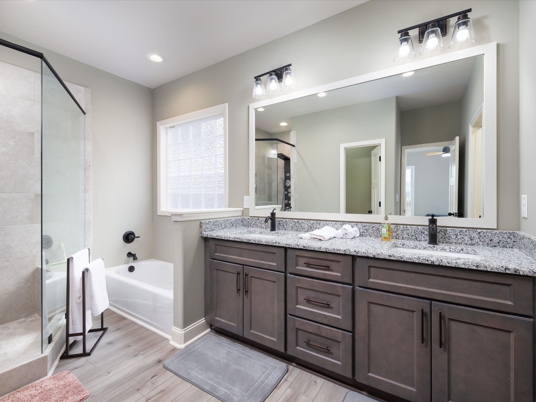 125 Charlie Howell Road Goodspring, TN 38460 - Photo 28 of 46 a spacious bathroom with a granite countertop sink a mirror and a bathtub