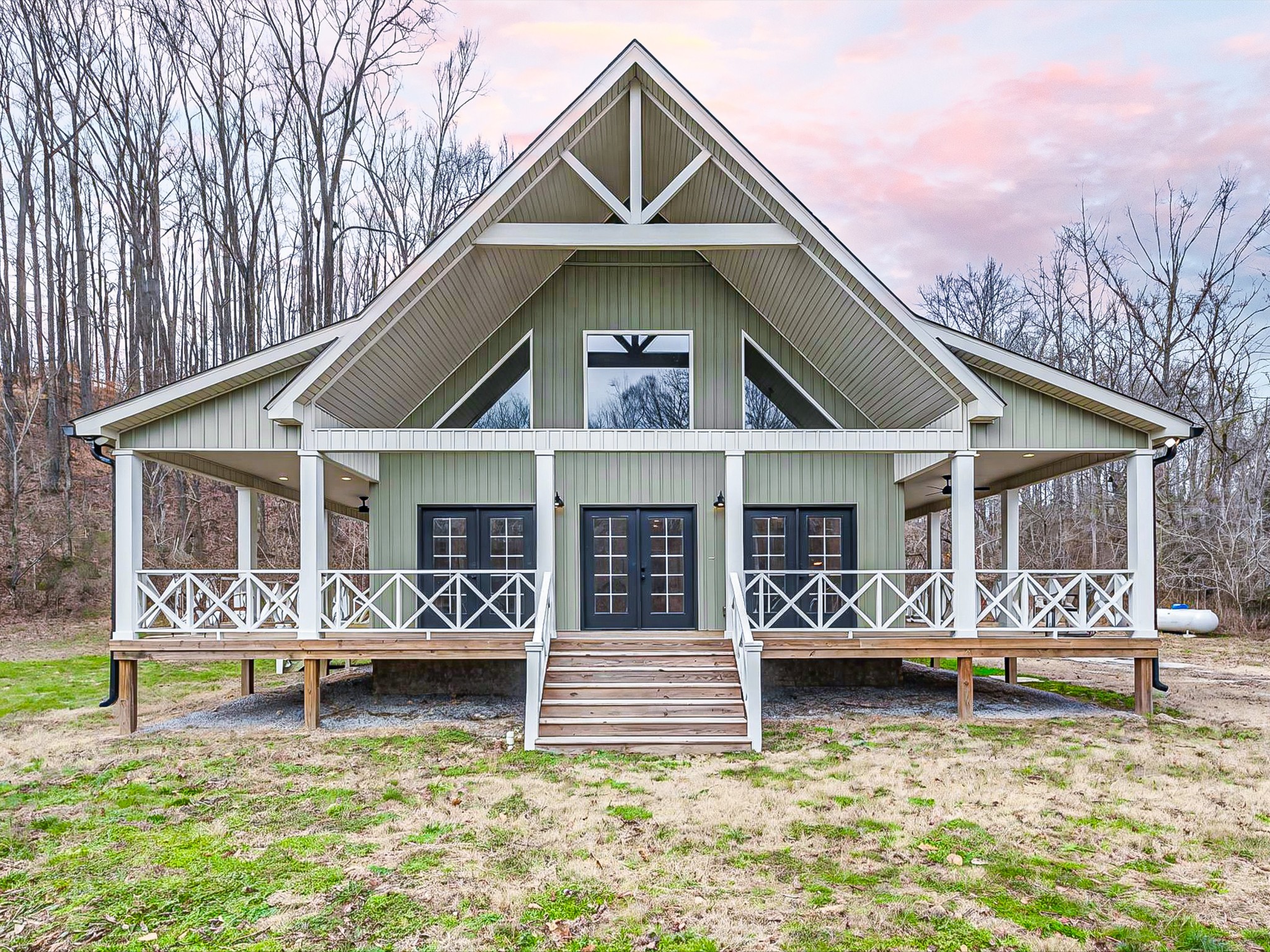 125 Charlie Howell Road Goodspring, TN 38460 - Photo 3 of 46 a front view of a house with large windows and a yard table