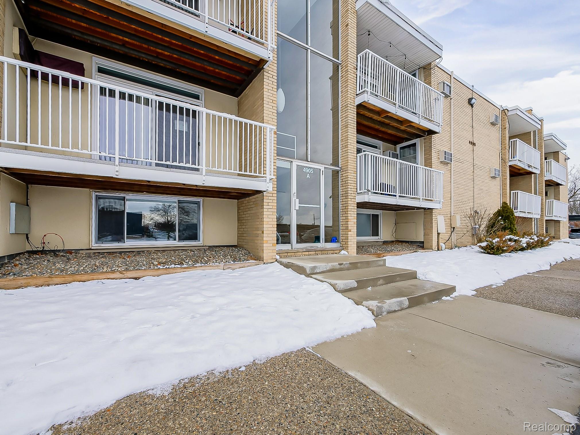 4905 South Crooks Road Royal Oak, MI 48073 - Photo 23 of 28 Snow covered building featuring a view of apartment building / complex