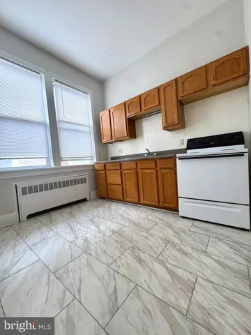 a view of a kitchen with microwave and cabinets