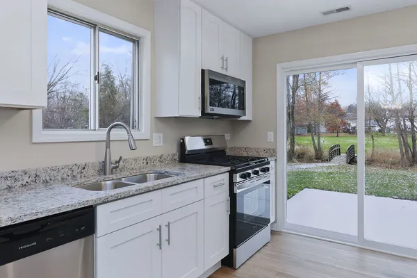 a kitchen with a sink stove and cabinets