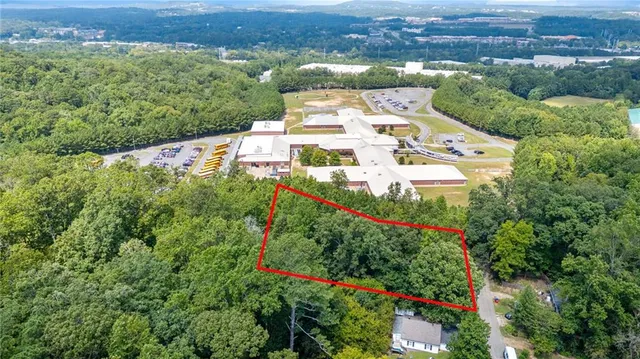 an aerial view of a house with a yard and lake view