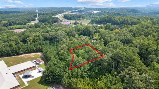 an aerial view of a house with a yard and lake view