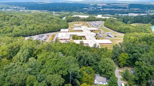 an aerial view of a house with a yard and lake view