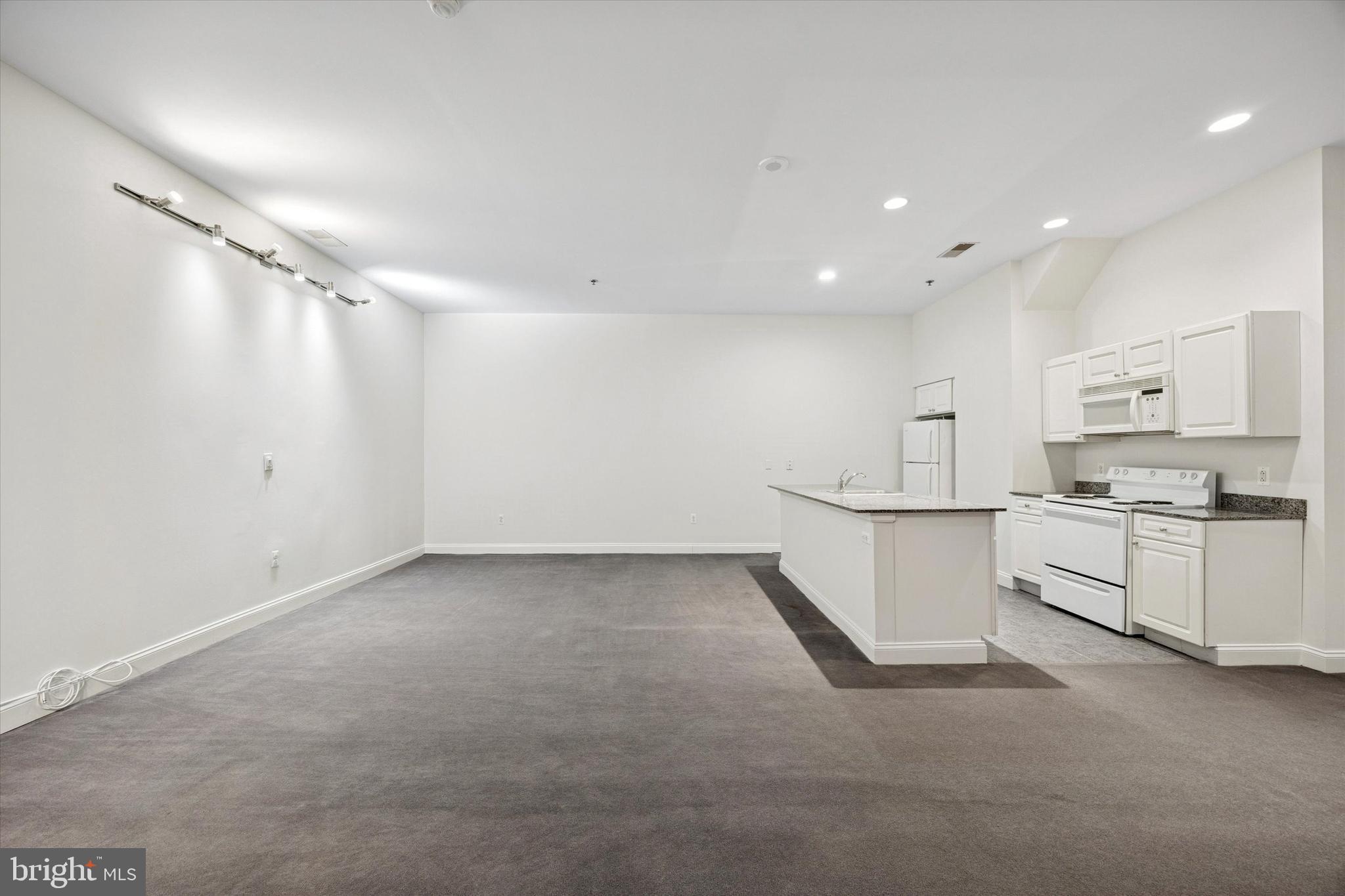 1001 Chestnut Street, Unit 205W Philadelphia, PA 19103 - Photo 11 of 25 a view of a kitchen with white cabinets