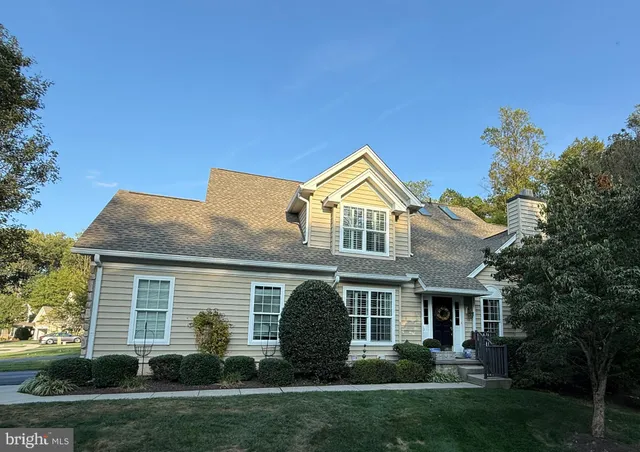 a front view of a house with a garden and plants