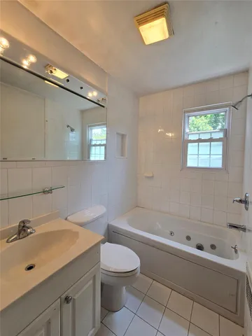 a bathroom with a sink a toilet and bathtub