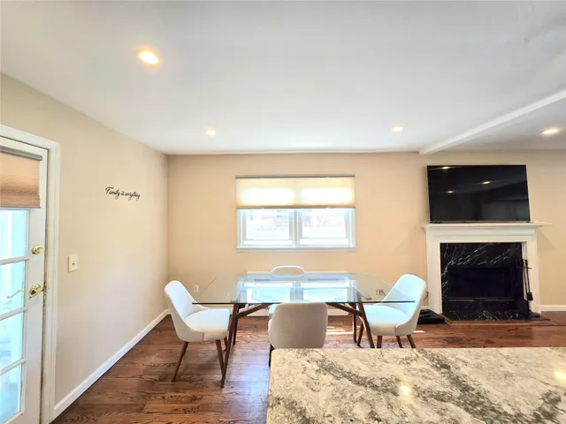 a living room with furniture a fireplace and a table