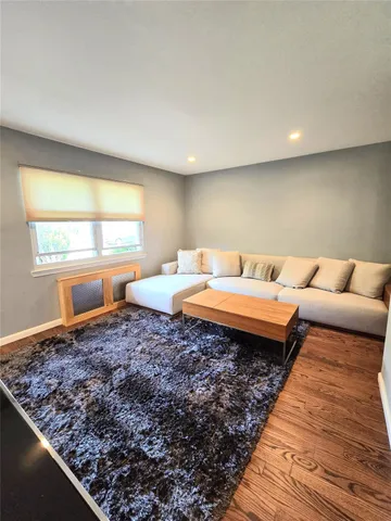 a living room with a couch and large windows