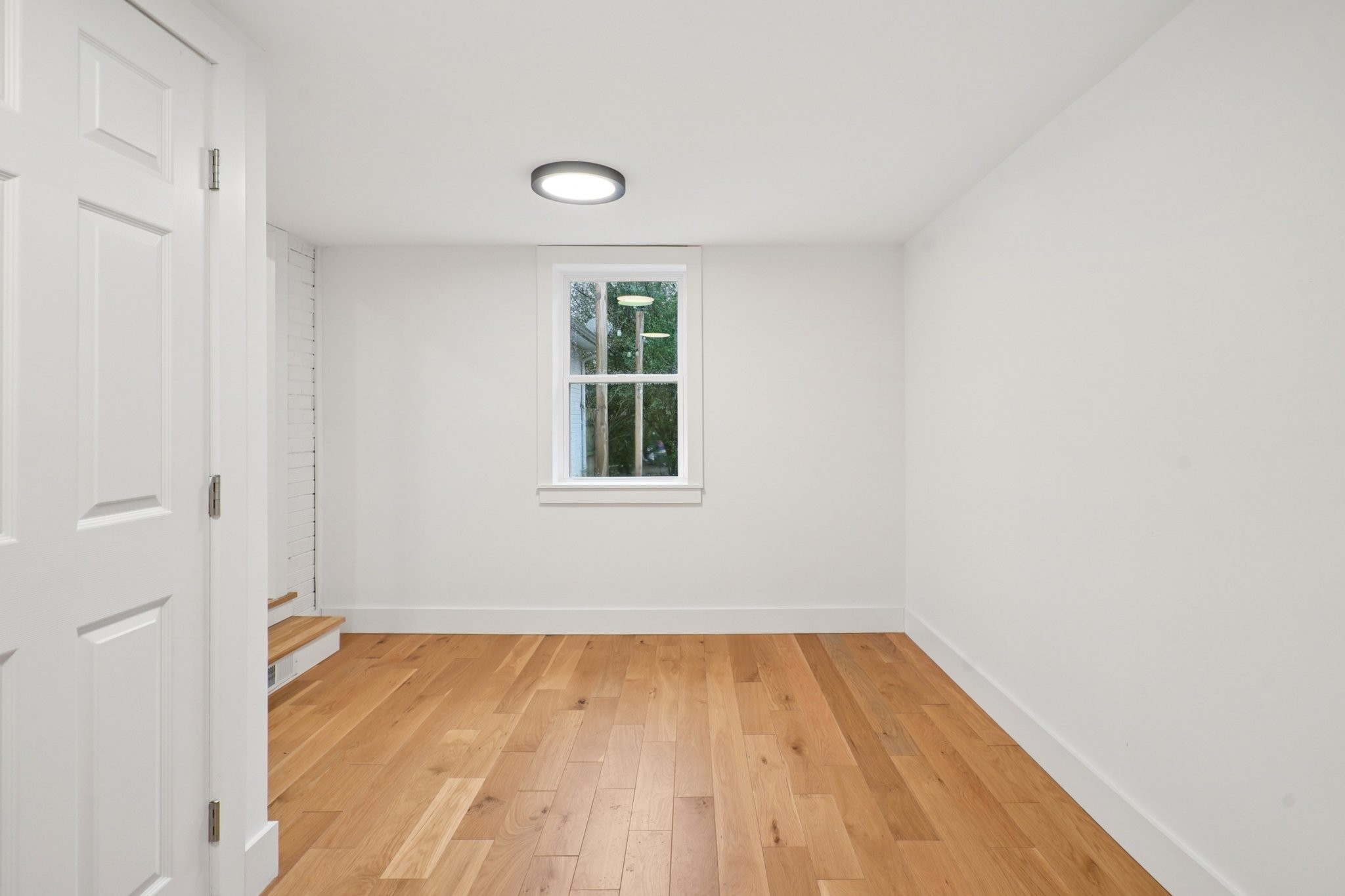1315 Robin Hill Road Franklin, TN 37064 - Photo 18 of 25 an empty room with a window and wooden floor