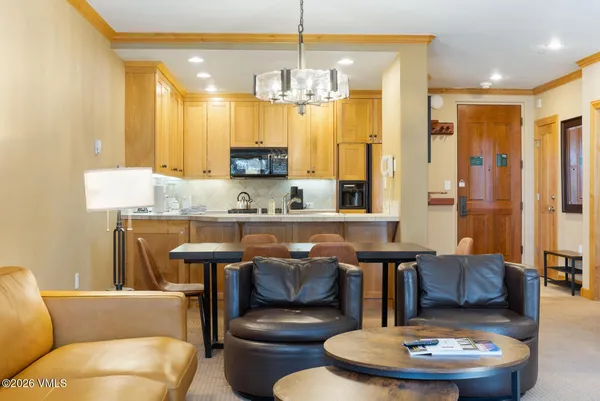 a kitchen with stainless steel appliances kitchen island granite countertop a table and chairs