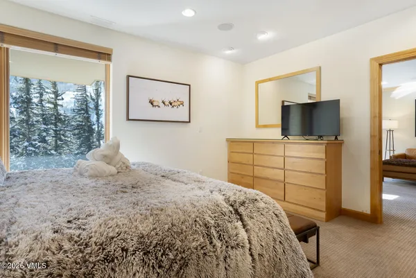 a bedroom with a bed and a flat screen tv