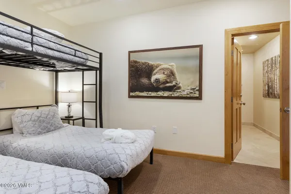 a bedroom with a bed and a painting on the wall