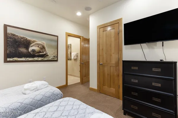 a bedroom with a bed and a television
