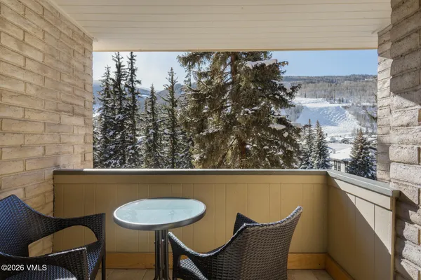 a view of a chairs and table in a balcony
