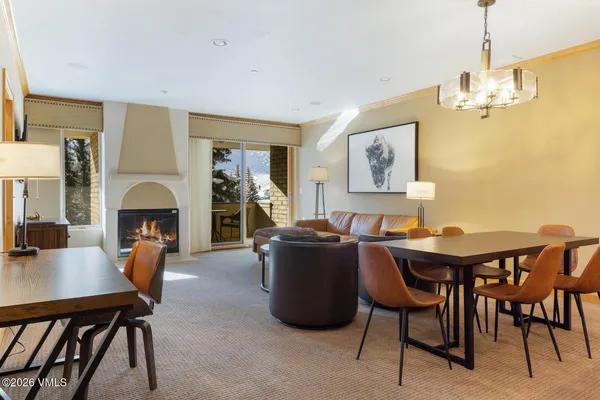 a view of a dining room with furniture and chandelier