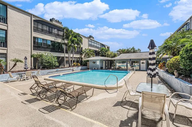 a view of a swimming pool with outdoor seating