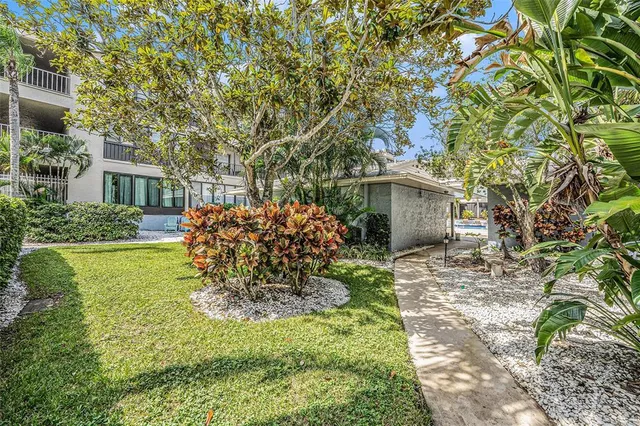 a view of a city with flower plants and wooden fence