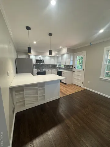 a kitchen with a sink a stove and cabinets