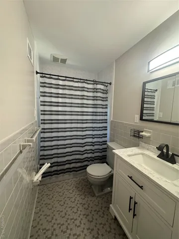 a bathroom with a sink toilet and mirror