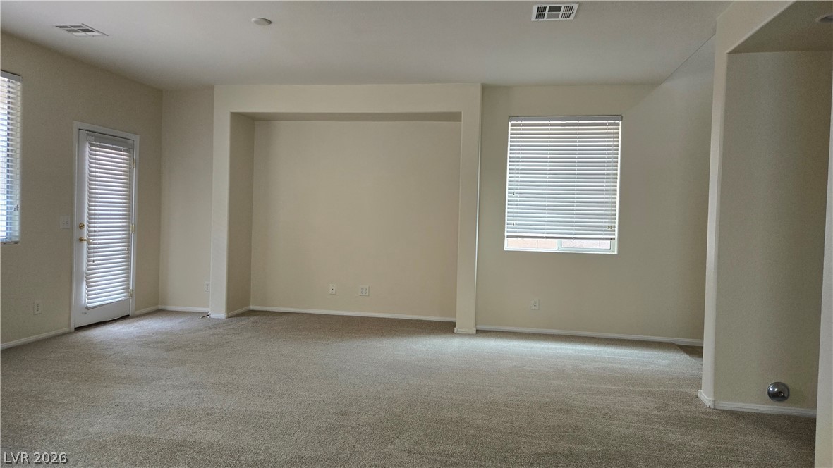 9031 Spring Star Court Las Vegas, NV 89148 - Photo 6 of 17 A spacious, neutral-toned room features soft carpeting and natural illumination from a large window.