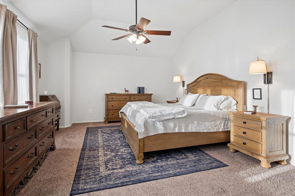 13837 High Mesa Road Fort Worth, TX 76262 - Photo 11 of 25 a bedroom with a bed and ceiling fan