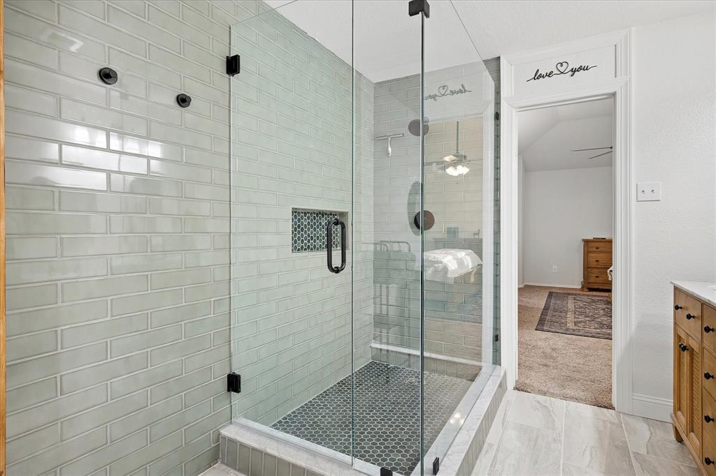 13837 High Mesa Road Fort Worth, TX 76262 - Photo 13 of 25 a bathroom with a glass shower door and a sink