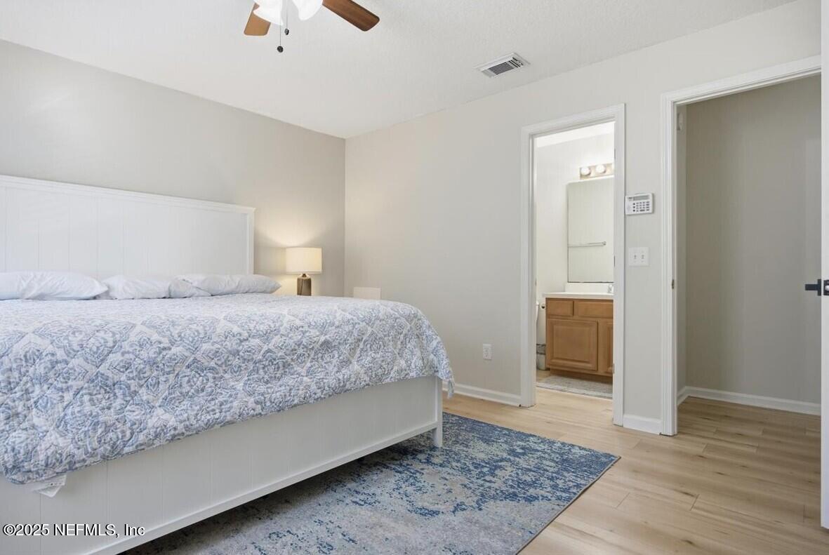 446 Scrub Jay Drive St. Augustine, FL 32092 - Photo 11 of 20 a bedroom with a bed and wooden floor