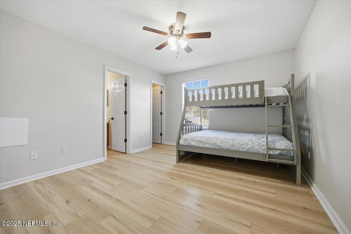 446 Scrub Jay Drive St. Augustine, FL 32092 - Photo 13 of 20 a bedroom with a bed and a chandelier