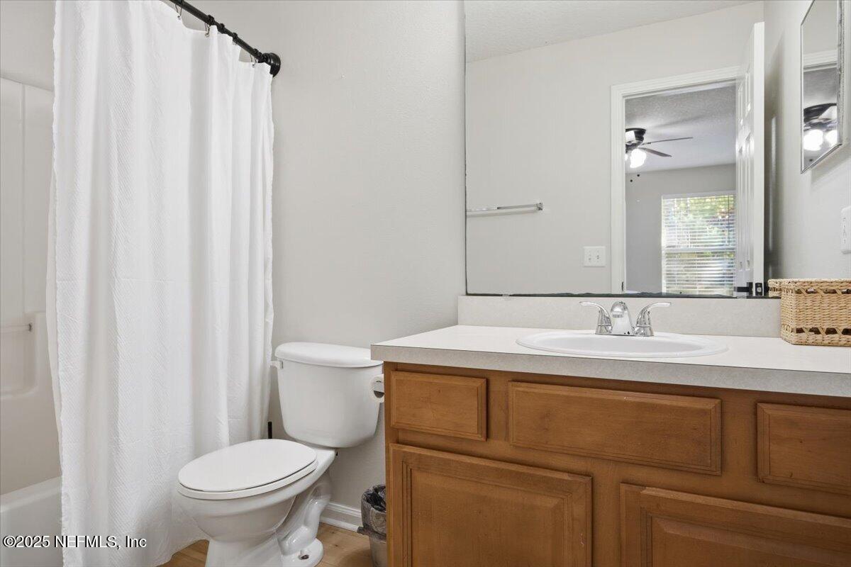 446 Scrub Jay Drive St. Augustine, FL 32092 - Photo 14 of 20 a bathroom with a granite countertop sink toilet and a mirror