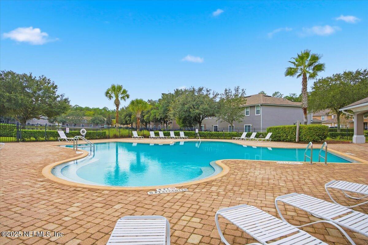 446 Scrub Jay Drive St. Augustine, FL 32092 - Photo 17 of 20 a view of swimming pool with outdoor seating and yard in back