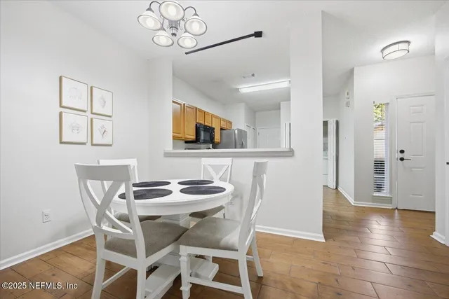 a view of a dining room with furniture and wooden floor