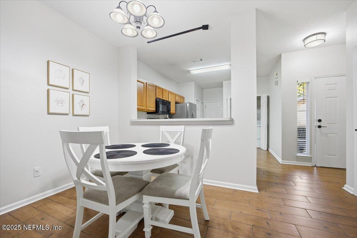 446 Scrub Jay Drive St. Augustine, FL 32092 - Photo 4 of 20 a view of a dining room with furniture and wooden floor