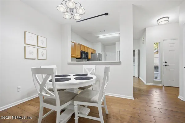 a view of a dining room with furniture and wooden floor