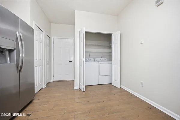 a living room with couches rug and view of kitchen