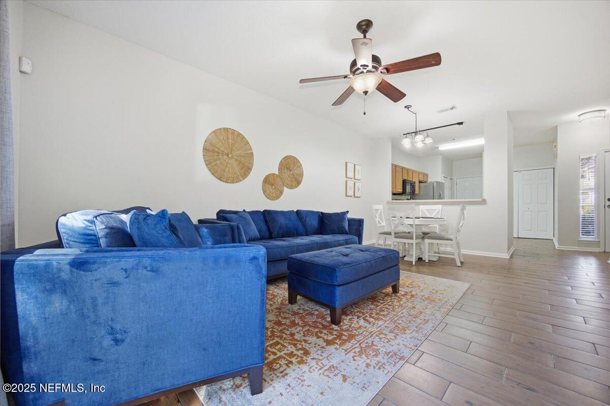 446 Scrub Jay Drive St. Augustine, FL 32092 - Photo 8 of 20 a living room with couches rug and view of kitchen