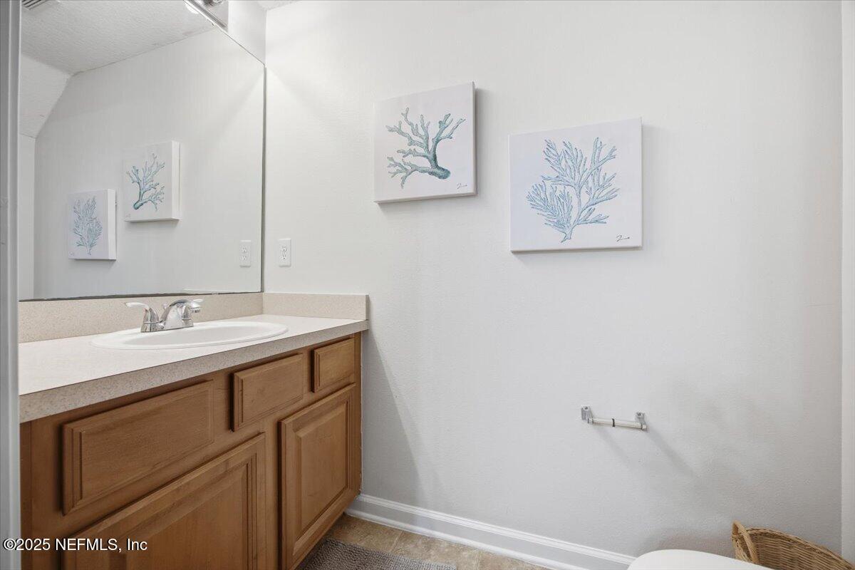 446 Scrub Jay Drive St. Augustine, FL 32092 - Photo 9 of 20 a bathroom with a sink and a mirror
