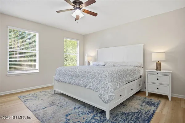 a bedroom with a bed and wooden floor